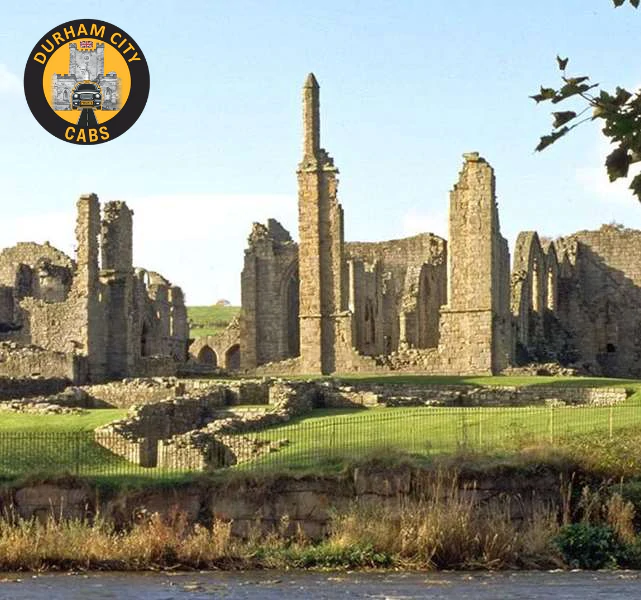 The scenic ruins of Finchale Priory, a 13th-century monastery, standing on a grassy bank next to the River Wear in Durham.